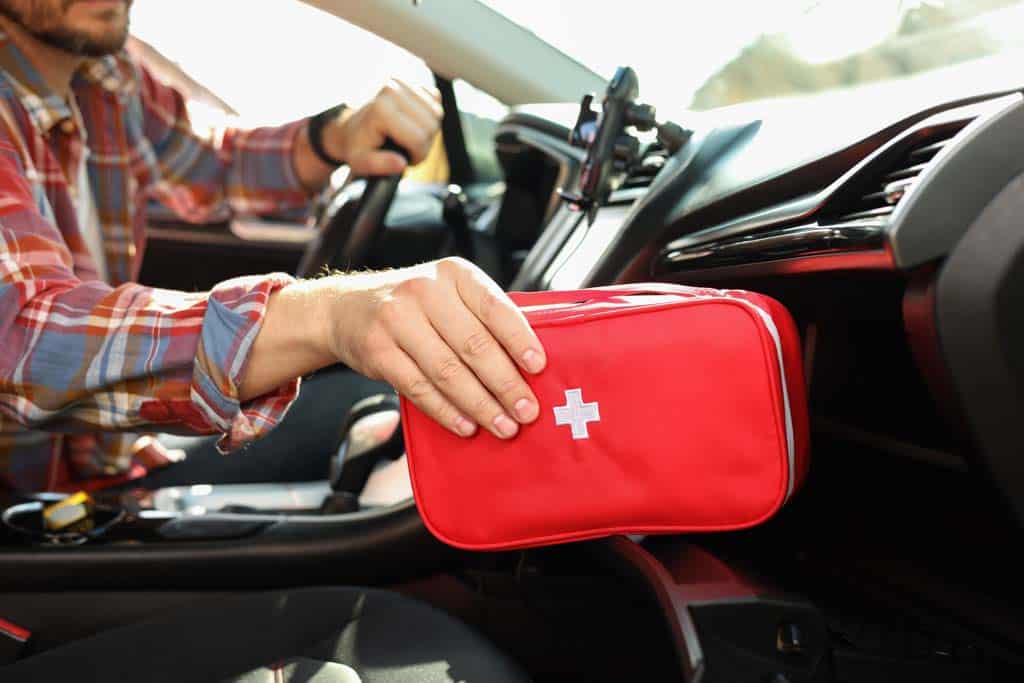 A man with a first aid kit in his car